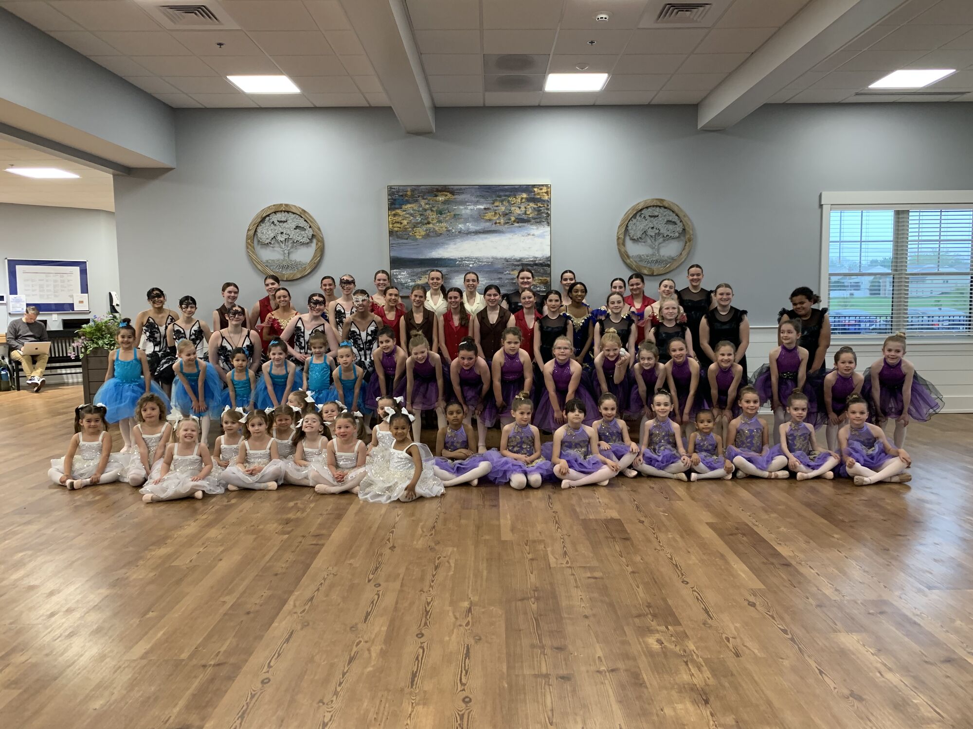 Dancers of all ages gathered in costume for a studio group photo